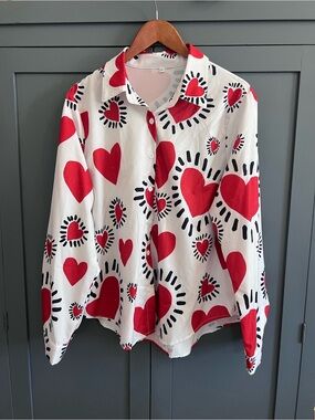 Keith Haring-inspired white blouse with red hearts.